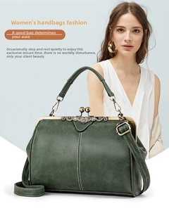 Macro shot of dark green matte leather vintage doctor bag with ornate bronze metal frame