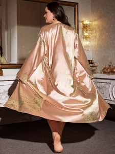 Rear view of a champagne floral satin robe with elegant botanical prints in a luxury room