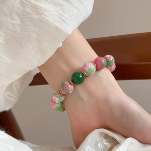 Vintage floral ceramic beaded stretch bracelet with green accent and gold-plated spacers