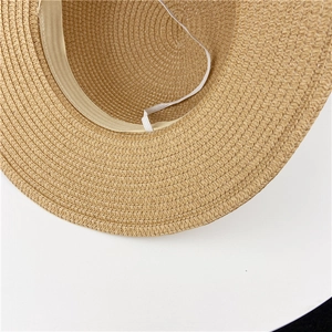 Detail of khaki straw hat featuring a white sweatband and elastic windproof chin strap