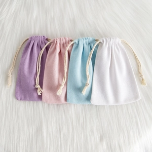 Detail showing high-quality thick canvas drawstring pouches in four pastel colors