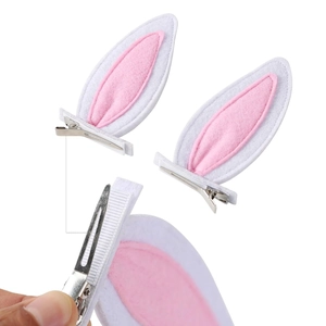 Detail of plush bunny ear hair clips with pink inner felt and silver alligator grip