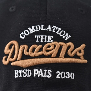 Black cotton baseball cap with 3D dream embroidery detail and classic textured fabric