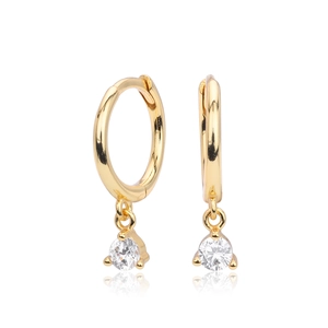 Detail of gold-plated silver huggie earrings with a 3-prong round cubic zirconia drop