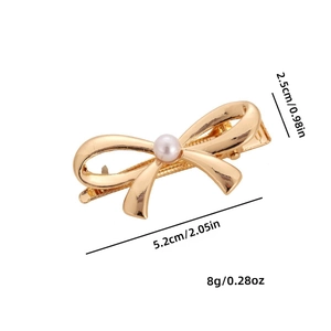 Golden metal bow hair clip with pearl center, 5.2cm long, minimalist professional photo