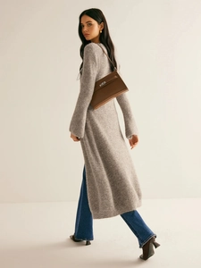 Brown leather top-handle bag styled with a long gray knit cardigan and flared jeans