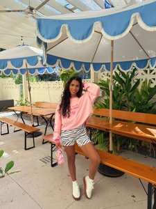 Women's pink crewneck sweatshirt with letter print paired with zebra pattern biker shorts