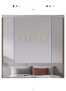 Detailed view of three minimalist golden wire coffee cup wall art pieces in a modern room