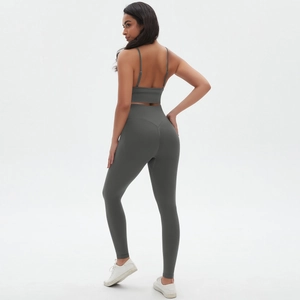Back view of a seamless dark gray yoga set featuring a strappy bra and high-waist leggings