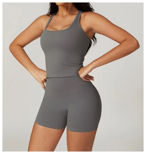 Detail showing grey racerback tank top and high waisted fitness shorts set for women