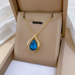 Blue teardrop crystal necklace with gold plated chain presented in a brown jewelry gift box