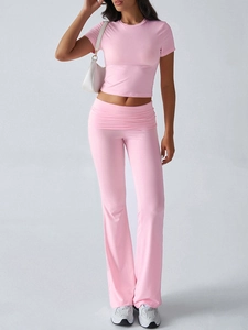 Detail view of pink casual two-piece set featuring a fitted short sleeve crop top and flared pants