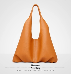 Close-up of brown litchi pattern leather texture on a minimalist hobo tote bag