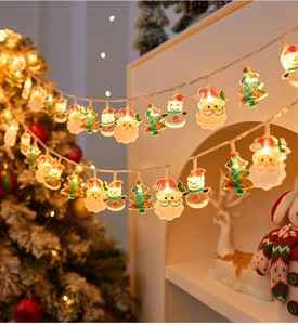 Close-up of warm white Christmas LED string lights featuring Santa and Snowman shapes
