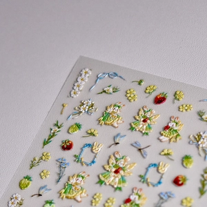 Detailed macro view of 3D embossed nail stickers with cute bunnies and floral patterns