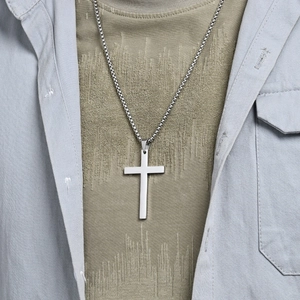 Polished silver stainless steel cross pendant necklace with box chain for men on model