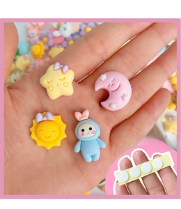 Close-up of 3D resin cartoon charms and adhesive pads for DIY thermal cup decoration