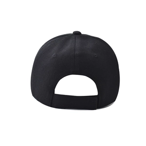 Detail of the adjustable velcro closure on the back of a black polyester baseball cap