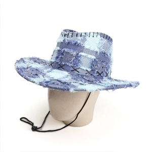 Detail of distressed denim cowboy hat with raw edges and decorative cross-stitch seams