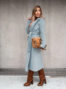 Detail of light blue wool blend overcoat with a belted waist and classic lapel collar