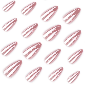 Minimalist nude press-on nails with white polka dots and stripe patterns in almond shape
