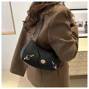 Retro black shoulder bag with gold twist lock shown worn with a brown wool blazer