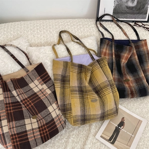 Detailed view of three vintage plaid wool tote bags in coffee, yellow and dark grey colors