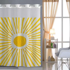 Detail of white waffle weave shower curtain featuring a yellow sunburst graphic and metal rings