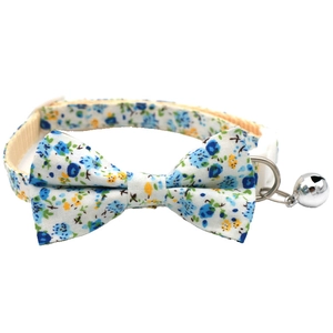 Detailed view of blue floral pet collar with cotton bowknot and metal safety bell