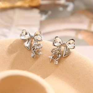 Elegant silver bow stud earrings with heart-shaped crystals and star charm pendants