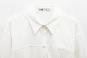 Close-up of a white button-down shirt collar with a YHWM brand size label inside