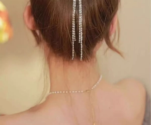 Detail of silver rhinestone tassel chain accessory for bun hairstyle and elegant ponytail