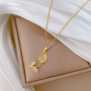 Macro detail of tulip pendant with cat eye stone and tiny diamonds on silk fabric