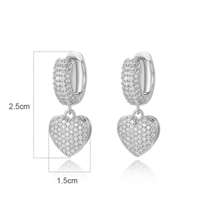 Detailed size view of silver heart earrings with pavé crystals measuring 2.5cm in length
