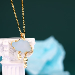 Gold-plated cloud pendant necklace with blue chalcedony and hanging raindrop charms