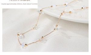 Detailed macro view of 14K gold-filled chain with 5x8mm iridescent white crystals