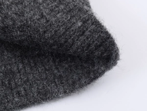 Close-up of premium dark grey knit fabric showing soft wool fibers and texture