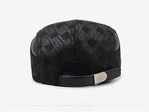 Detail of black baseball cap showing the textured fabric and adjustable leather strap back