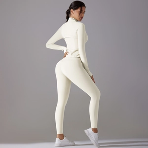 Detail of slim-fit two-piece sports set with zippered top and high-waist yoga leggings
