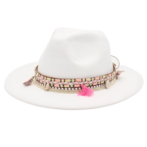 Close-up of ethnic fedora with colorful tassels, woven band, and cowrie shell accents