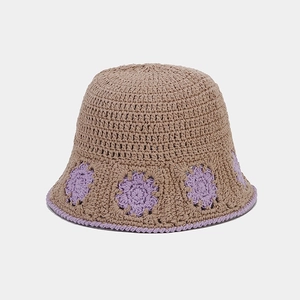Detailed close-up of handmade crochet bucket hat with purple floral knit patterns