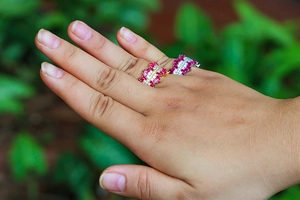 Detail of adjustable open rings in gold and silver finish with colorful zircon stones