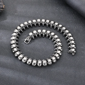 Punk style skull head necklace in vintage silver steel finish on textured background