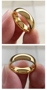 Detailed macro view showing the polished gold-finish surface and smooth curved ring band
