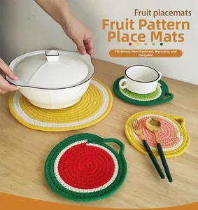 Close-up of a fruit-shaped braided cotton placemat with insulation and hanging hole