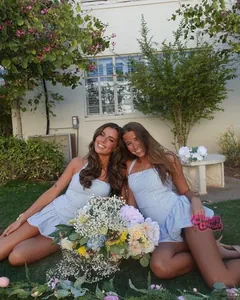Dettaglio di un mini abito a righe bianche e blu con orlo a balze in un giardino all'aperto