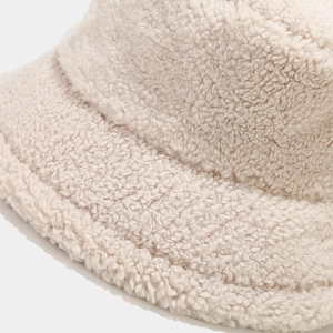 Close-up of premium cream sherpa fleece bucket hat showing plush texture and stitching