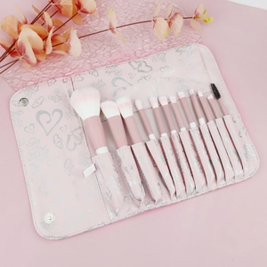 Detail of 12-piece pink makeup brush set with soft gradient bristles and heart storage bag