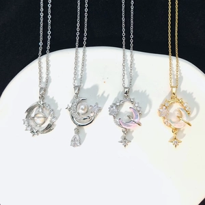 Star and moon necklace set in gold and silver finish with pearls and colored gemstones
