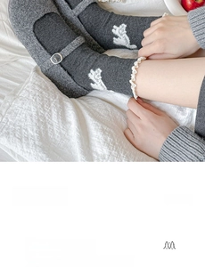 Detail of grey combed cotton crew socks with white lace trim and cute cat jacquard pattern